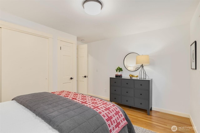 bedroom with baseboards and light wood finished floors