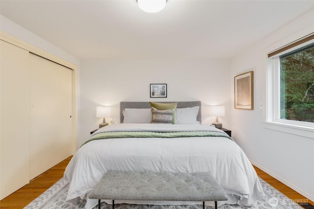 bedroom with a closet and wood finished floors