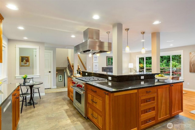 kitchen with appliances with stainless steel finishes, brown cabinetry, recessed lighting, and island range hood