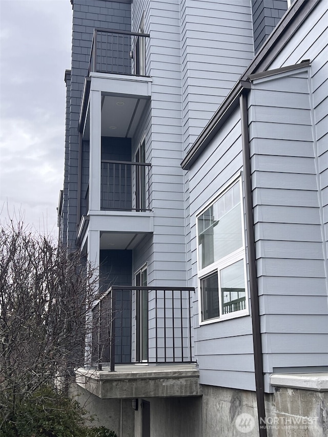 view of home's exterior with a balcony