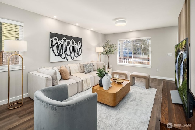 living room with dark wood-type flooring and plenty of natural light