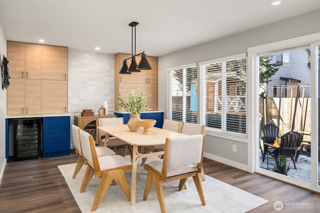 dining space featuring wood-type flooring and wine cooler