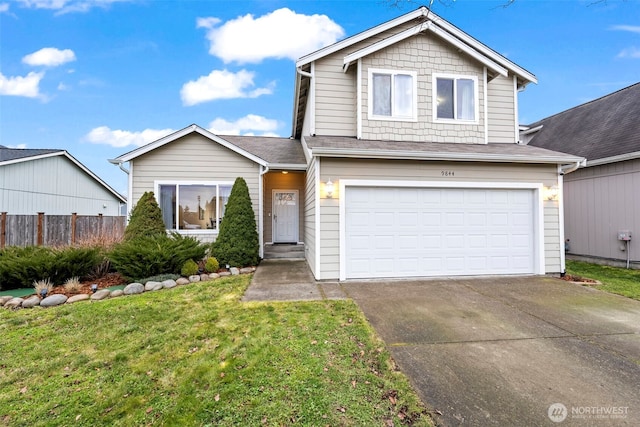 traditional-style home with fence, a front lawn, an attached garage, and driveway