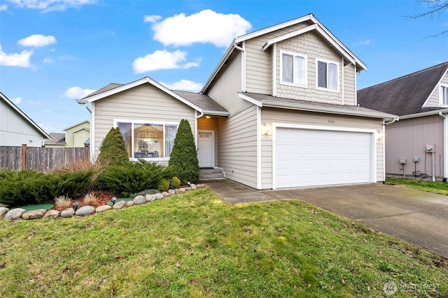 traditional-style home featuring fence, an attached garage, driveway, and a front yard