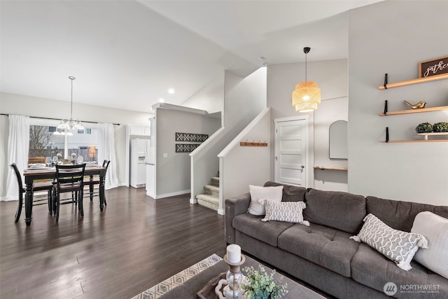 living area featuring vaulted ceiling, baseboards, stairs, and dark wood finished floors