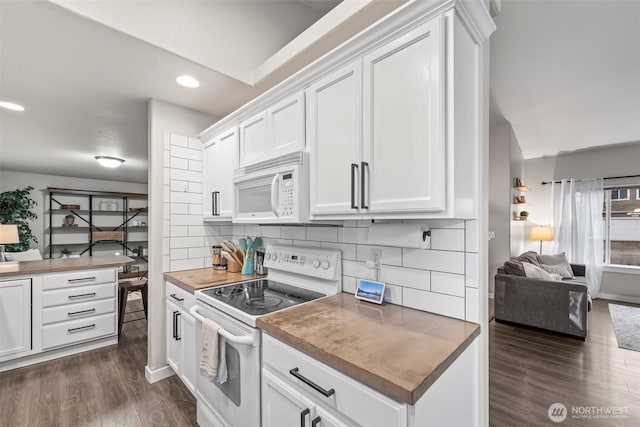 kitchen with open floor plan, white appliances, white cabinetry, dark wood finished floors, and backsplash