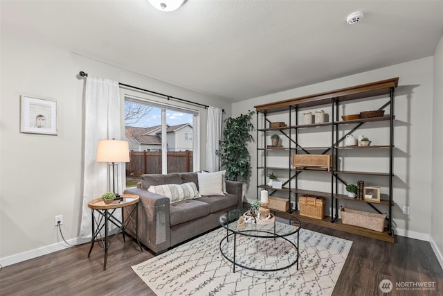 living room with baseboards and dark wood-style floors