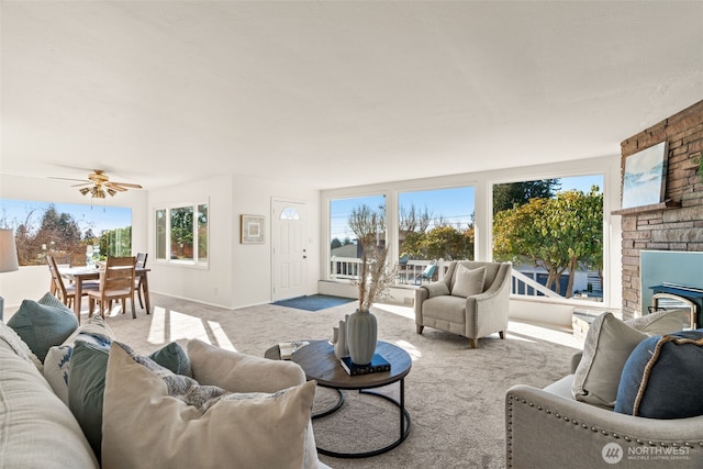 carpeted living room with ceiling fan