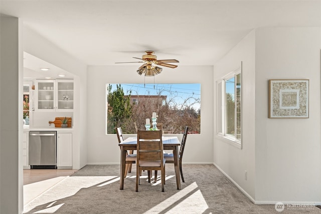 carpeted dining area featuring ceiling fan