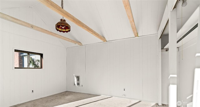 spare room featuring vaulted ceiling with beams