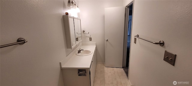 bathroom with tile patterned floors and vanity