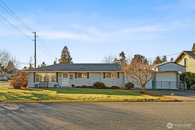 ranch-style house featuring a garage and a front yard