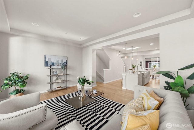 living room with sink and light hardwood / wood-style floors