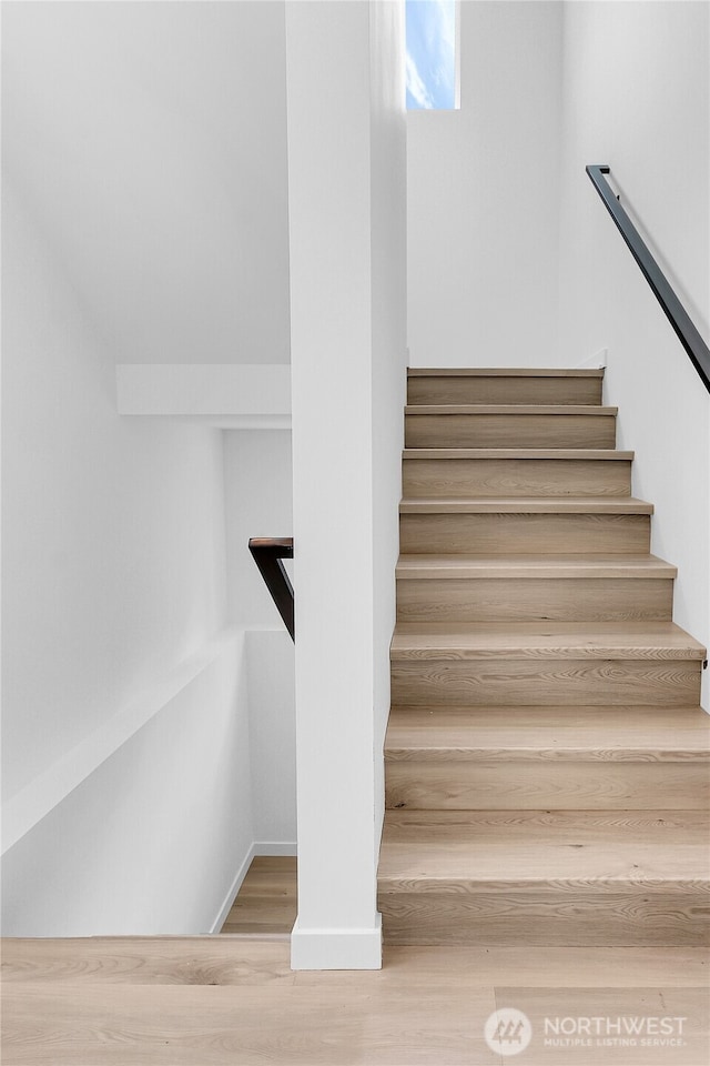 stairs with hardwood / wood-style floors