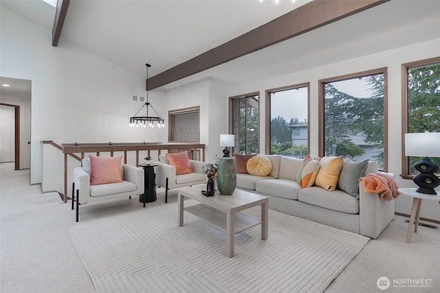 carpeted living room featuring beam ceiling and high vaulted ceiling