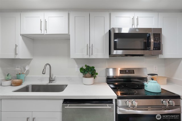 kitchen with sink, stainless steel appliances, and white cabinets