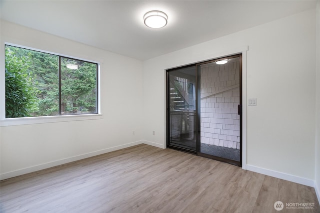 unfurnished room with light wood-type flooring