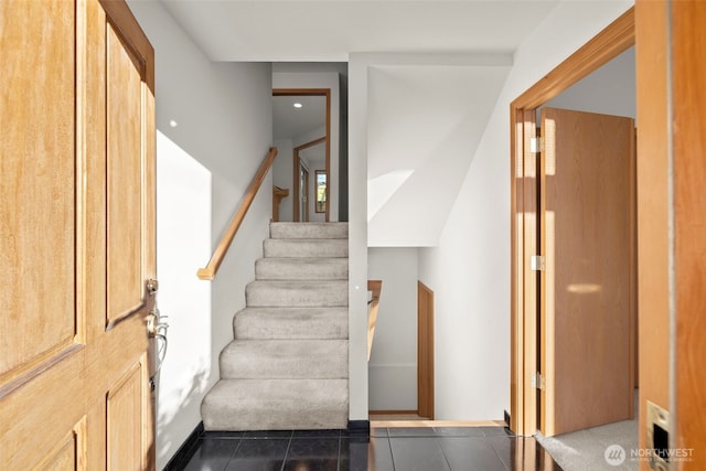 stairway featuring tile patterned flooring