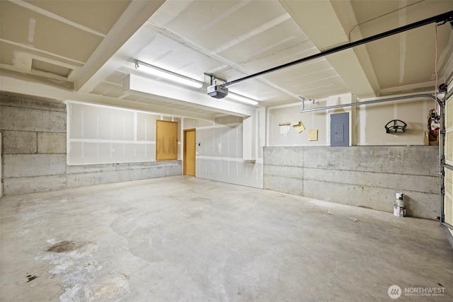 garage featuring a garage door opener and electric panel