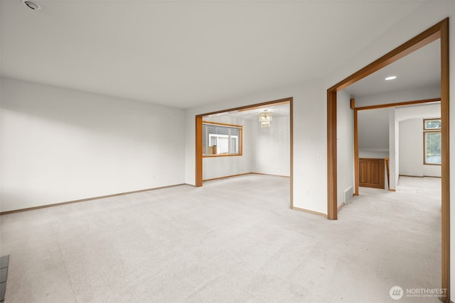 carpeted empty room with plenty of natural light