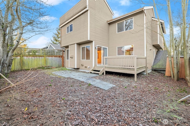 back of property with a wooden deck