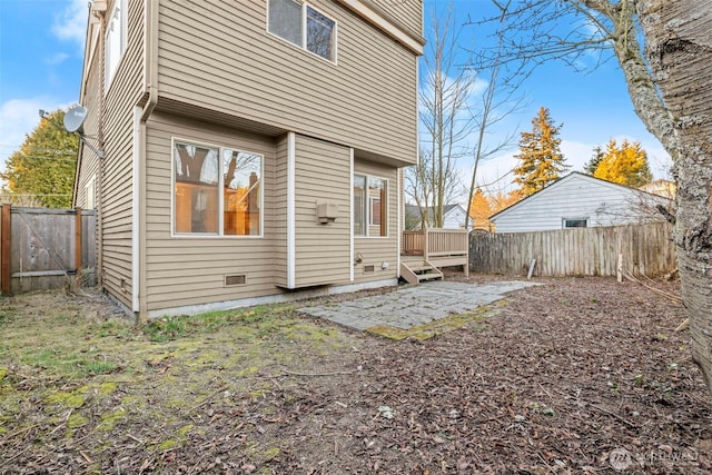 rear view of house with a deck and a patio area