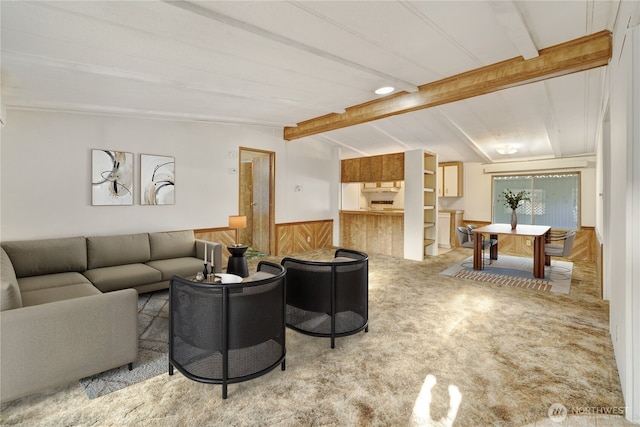 living room featuring carpet floors, lofted ceiling with beams, and wooden walls