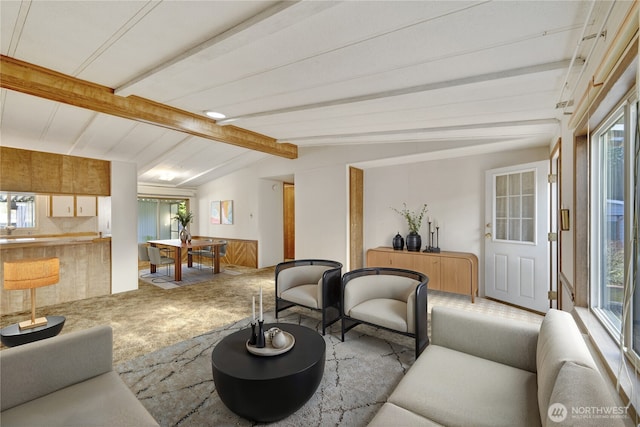 living room with carpet floors and vaulted ceiling with beams