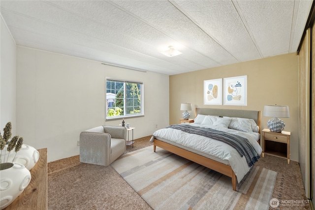 carpeted bedroom featuring a textured ceiling