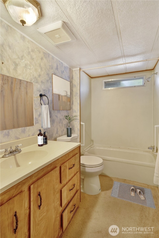 full bathroom featuring vanity, bathtub / shower combination, toilet, and a textured ceiling