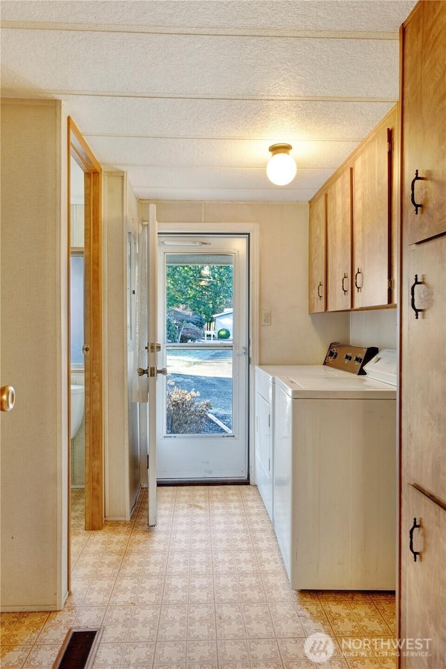 laundry area with cabinets and washer and dryer