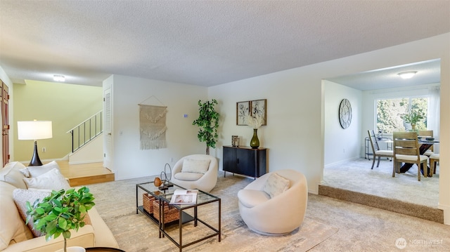 living room featuring light colored carpet and a textured ceiling