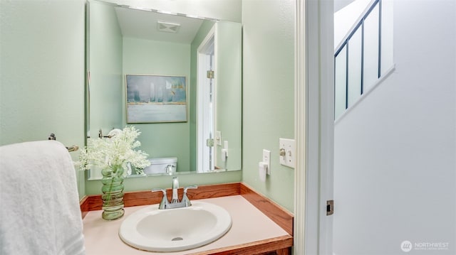 bathroom featuring vanity and toilet