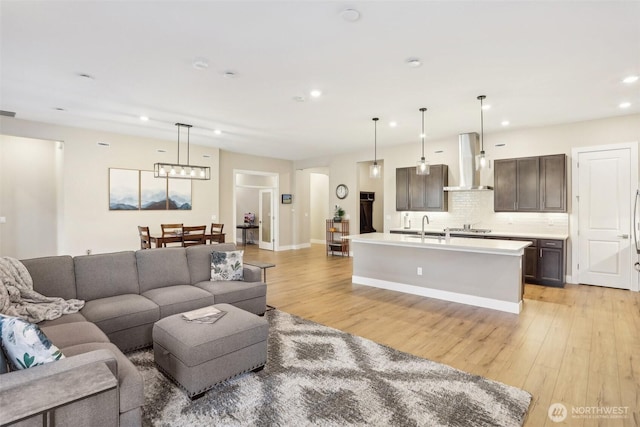 living room featuring sink and light wood-type flooring