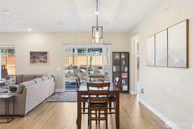 dining space with light hardwood / wood-style flooring