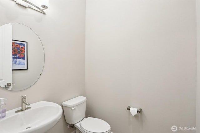 bathroom featuring sink and toilet