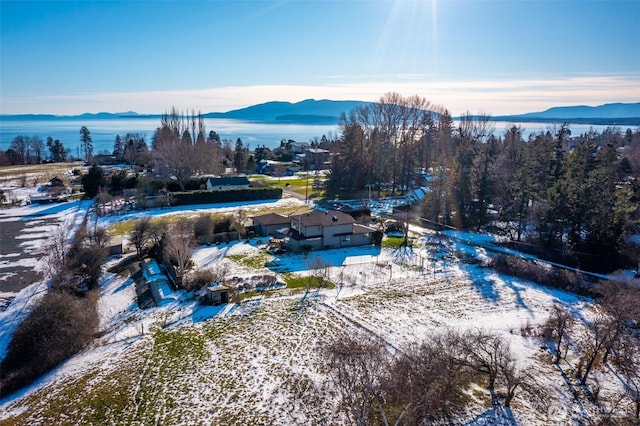 snowy aerial view with a mountain view