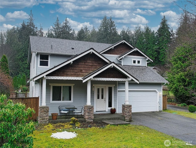 craftsman house featuring covered porch and a garage