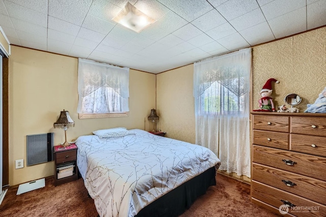 bedroom with multiple windows, dark colored carpet, and crown molding