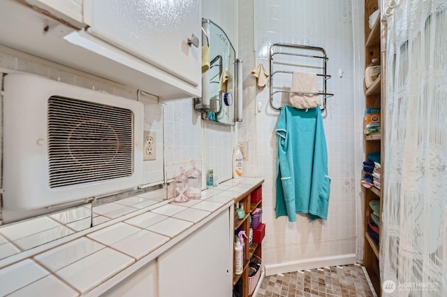 bathroom with tile walls