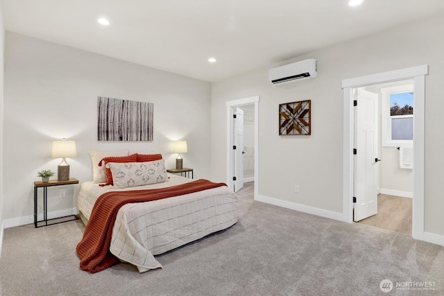 bedroom with light colored carpet, ensuite bath, and an AC wall unit