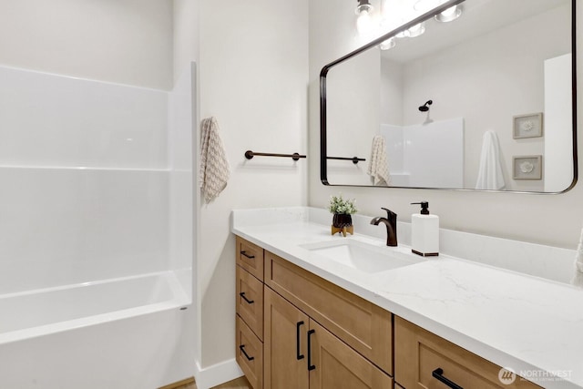 bathroom with vanity and shower / washtub combination