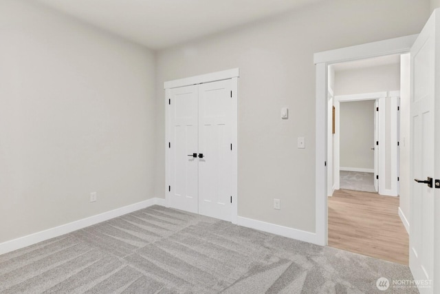 unfurnished bedroom featuring a closet and light carpet