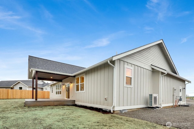 rear view of property featuring a lawn