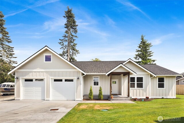 104 Sable Dr, Everson, WA 98247 - view of front of house featuring board and batten siding, roof with shingles, driveway, and a garage