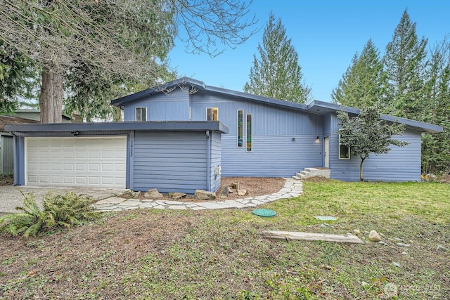 view of side of property featuring a garage and a yard