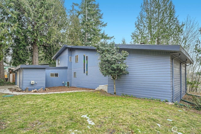 back of property featuring a yard and central AC unit