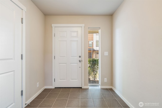 entrance foyer featuring dark tile patterned floors