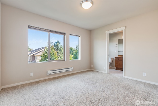 carpeted empty room featuring a baseboard heating unit