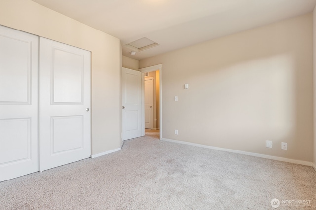 unfurnished bedroom with light carpet and a closet